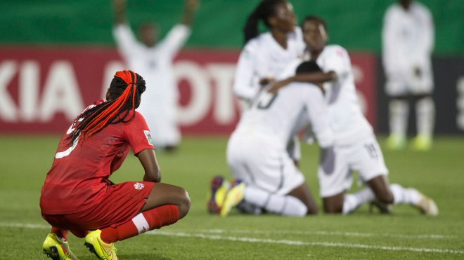 Kadeisha Buchanan can hardly look as Ghana celebrates its goal. 