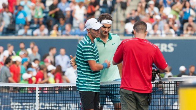 Peter Polansky (left) with Roger Federer after their match. 