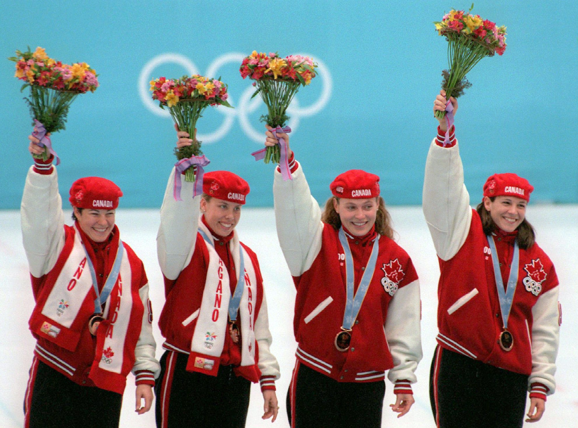Canadian Olympic Athletes Celebrate in Retro Inspired Red Podium