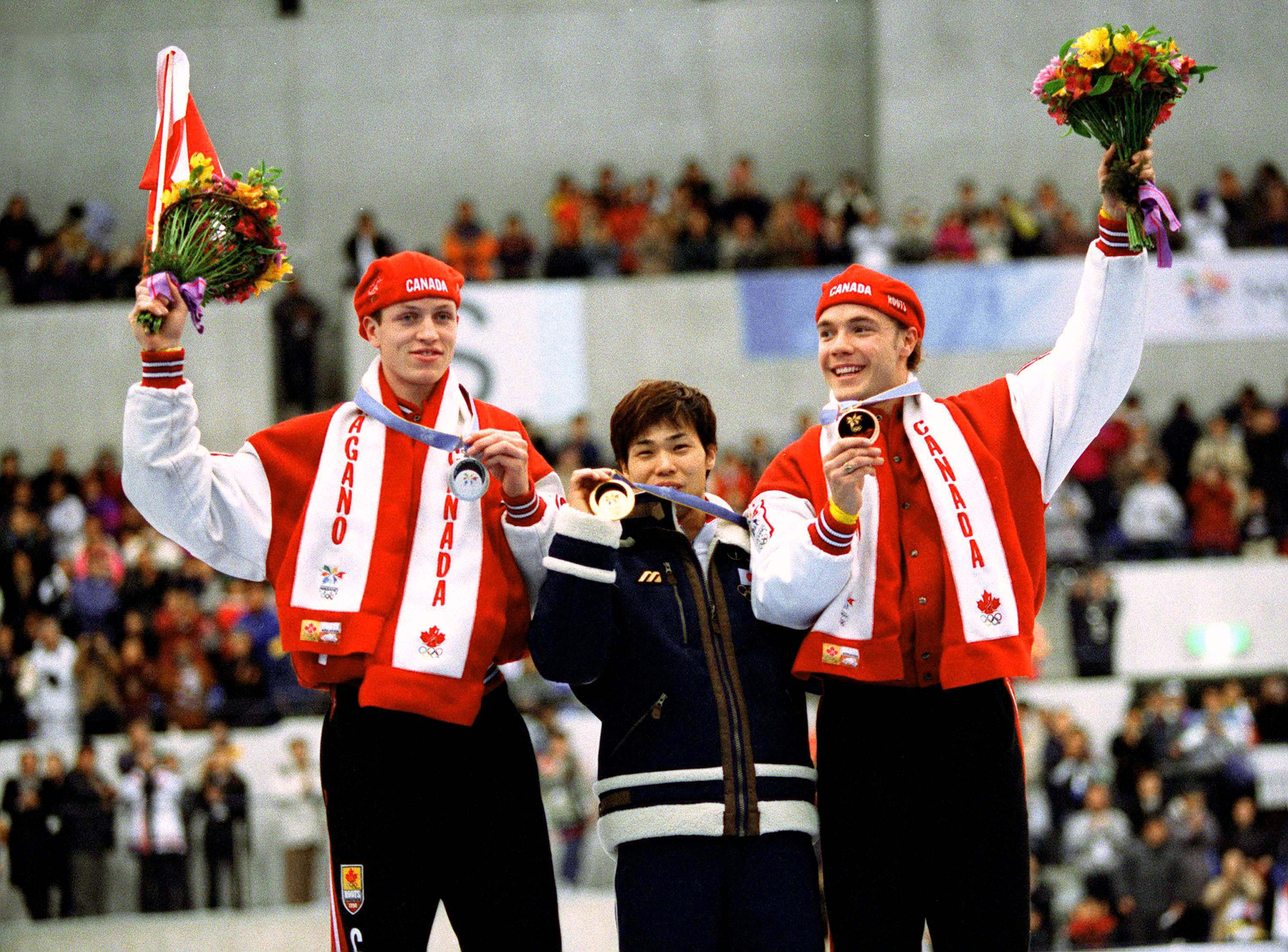 Canadian Olympic Athletes Celebrate in Retro Inspired Red Podium