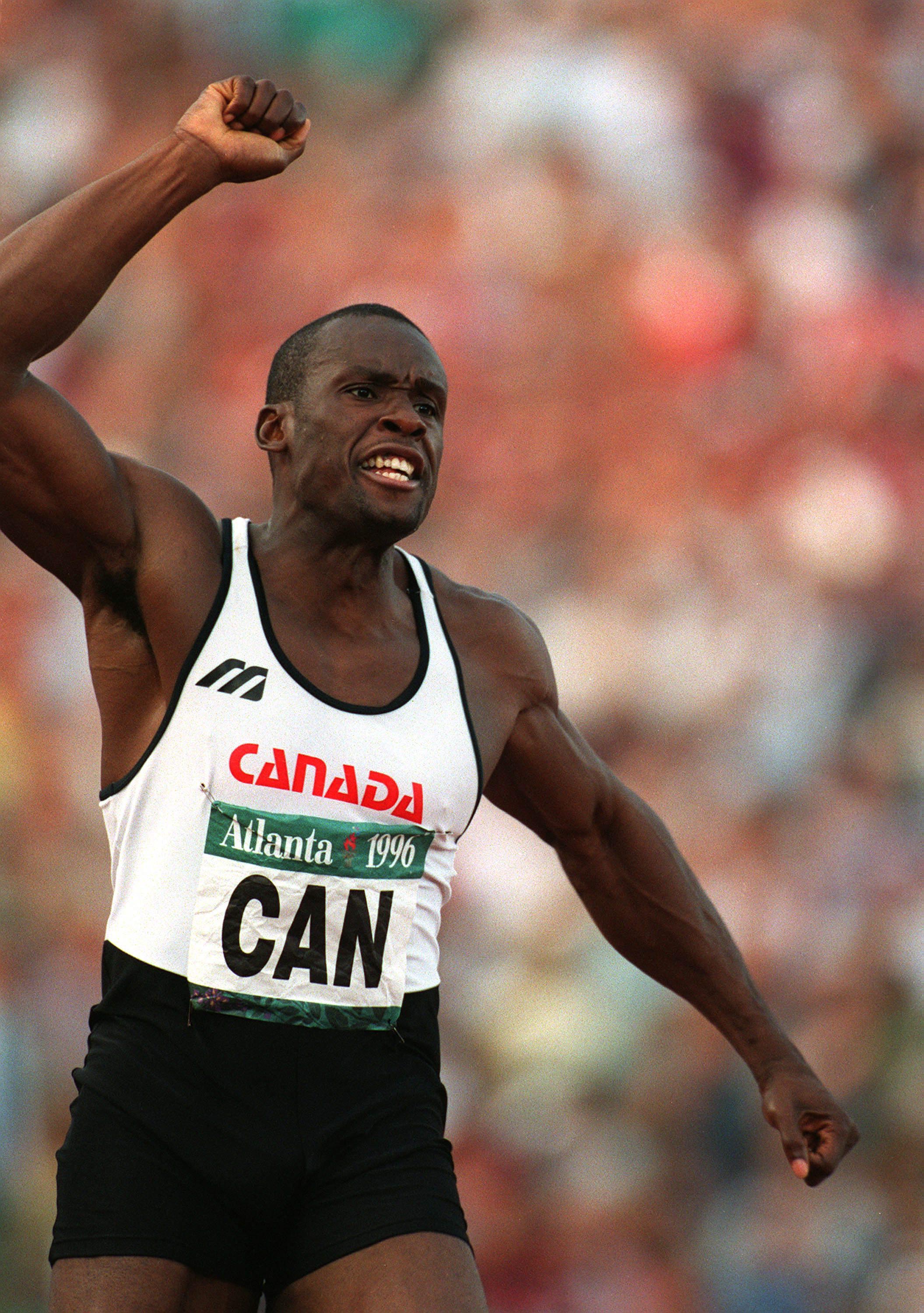 Bruny Surin celebrates with his arm in the air