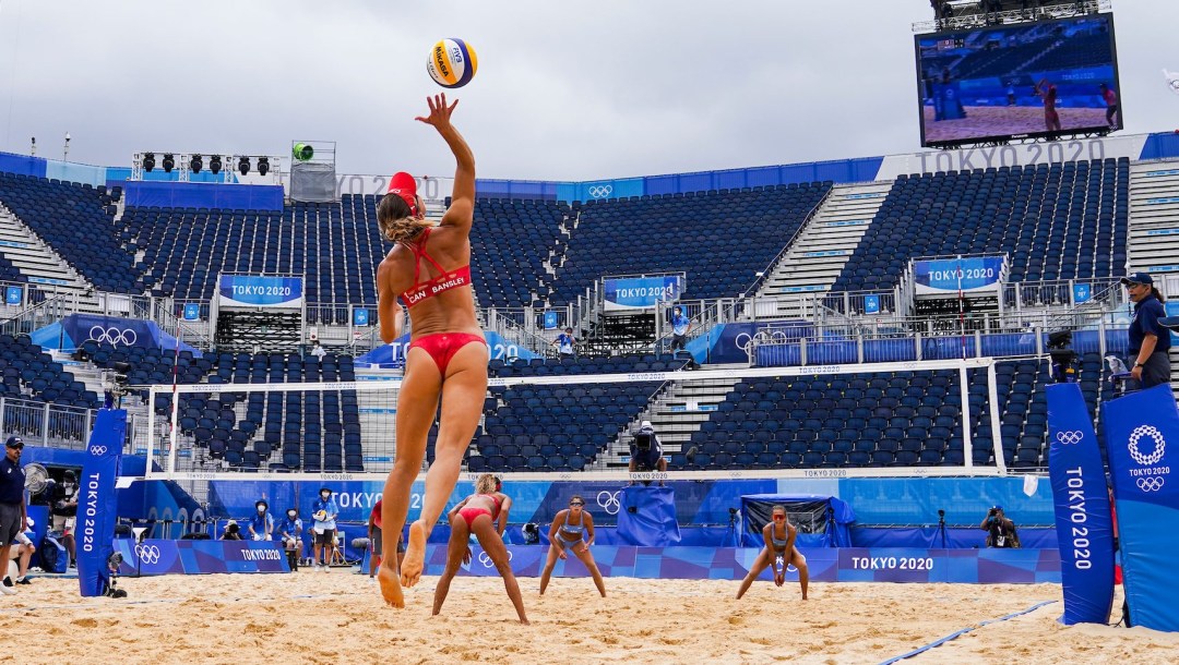 Wide shot of a serve being made in a beach volleyball game