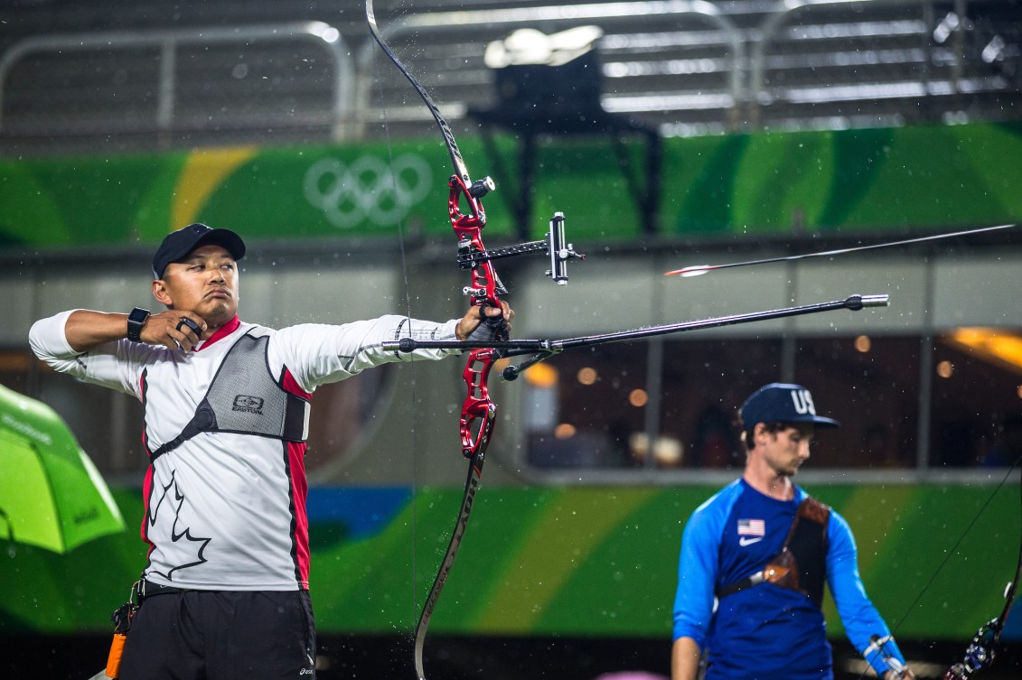Crispin Duenas releases his arrow in an archery competition
