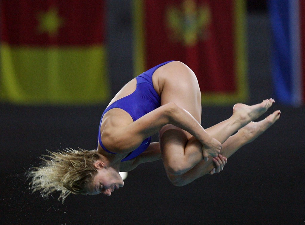 Emilie Heymans in tuck position as she performs a somersault dive 