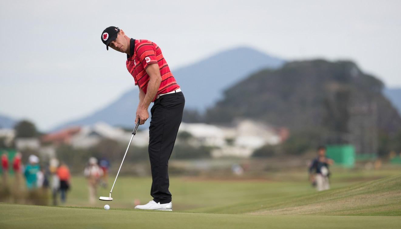 Graham DeLaet putts a golf ball 