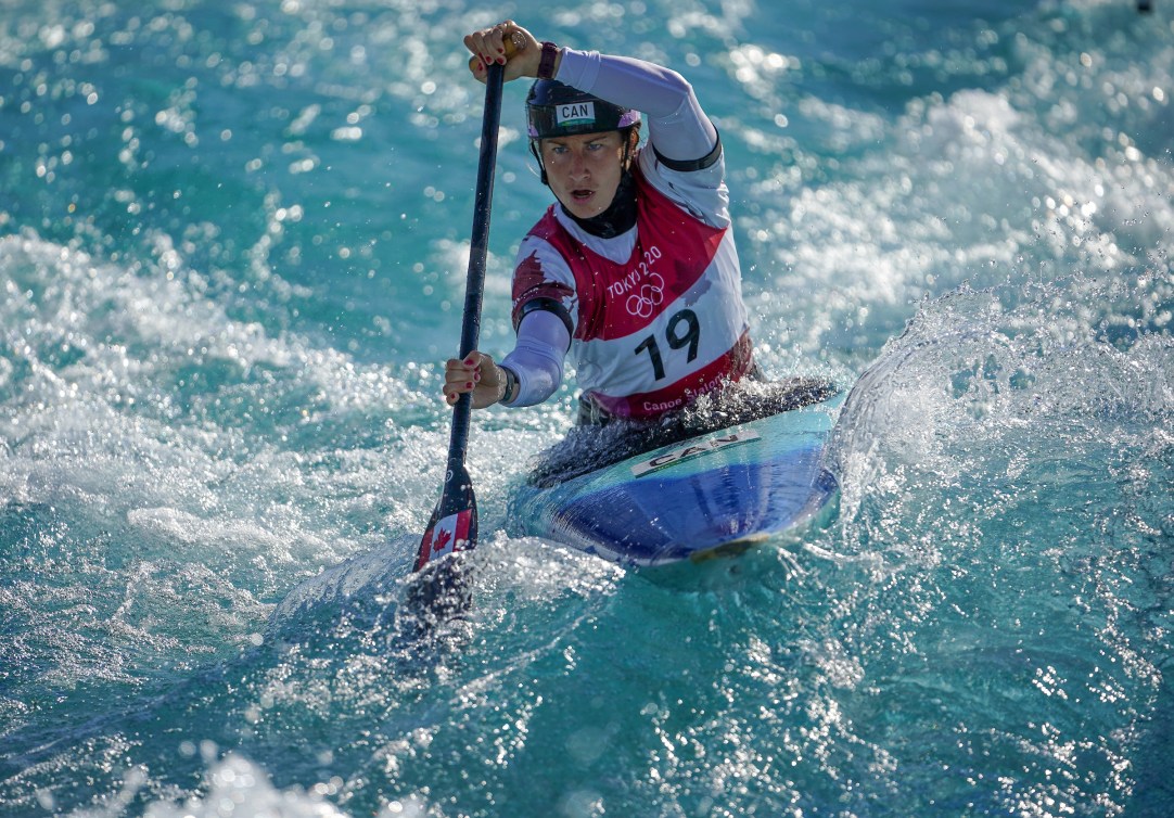 Haley Daniels paddles her canoe on a whitewater course