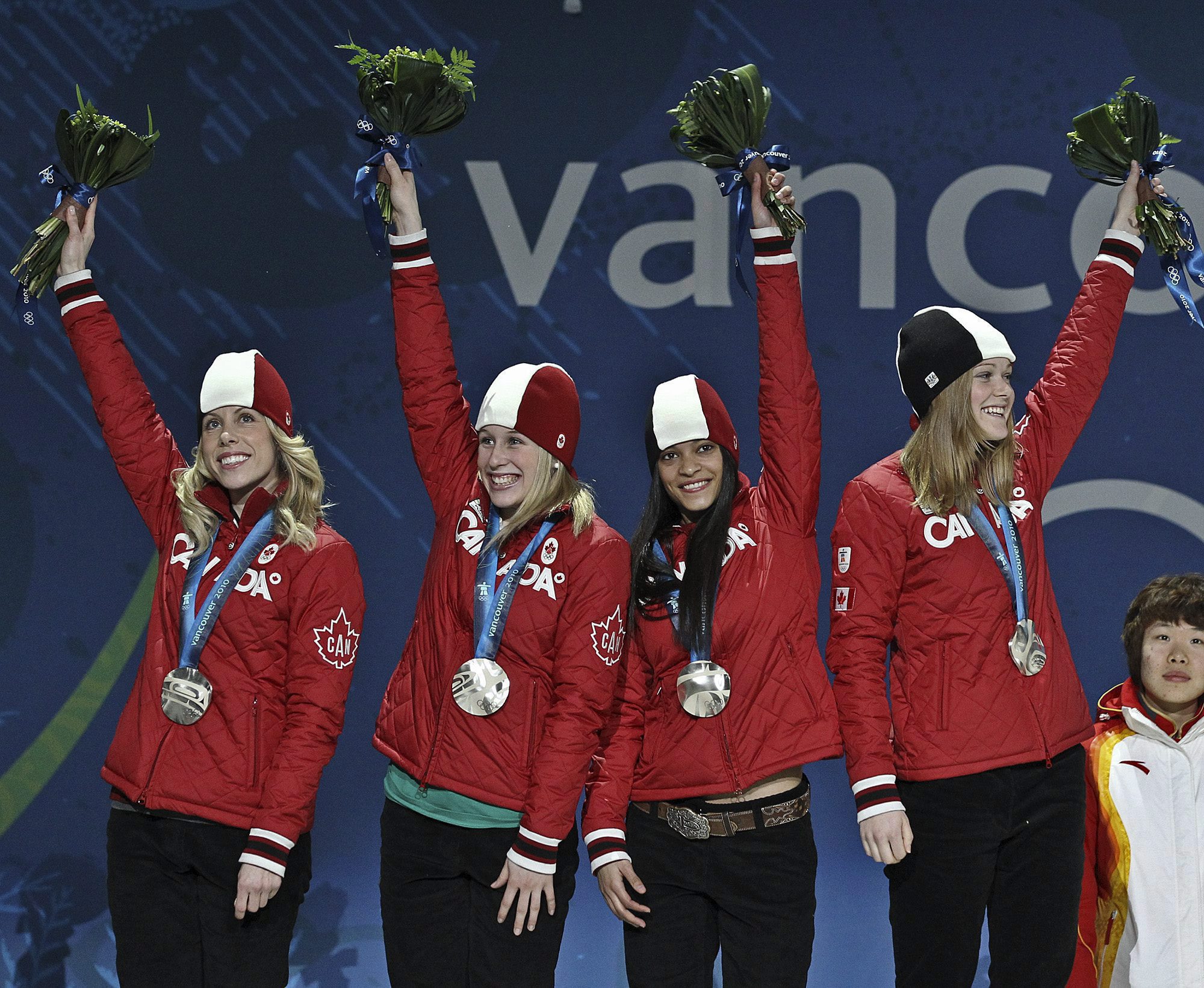 Canada’s women’s short-track relay team of Tania Vicent, Marianne St-Gelais, Kalyna Roberge and Jessica Gregg, from left to right, celebrate winning silver in the 3,000-metre relay during the medal ceremony at the 2010 Winter Olympics in Vancouver on Thursday evening, February 25, 2010, at BC Place. THE CANADIAN PRESS / Tara Walton
