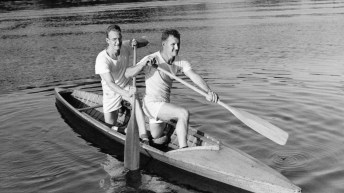 Black and white photo of two paddlers in a canoe from 1952