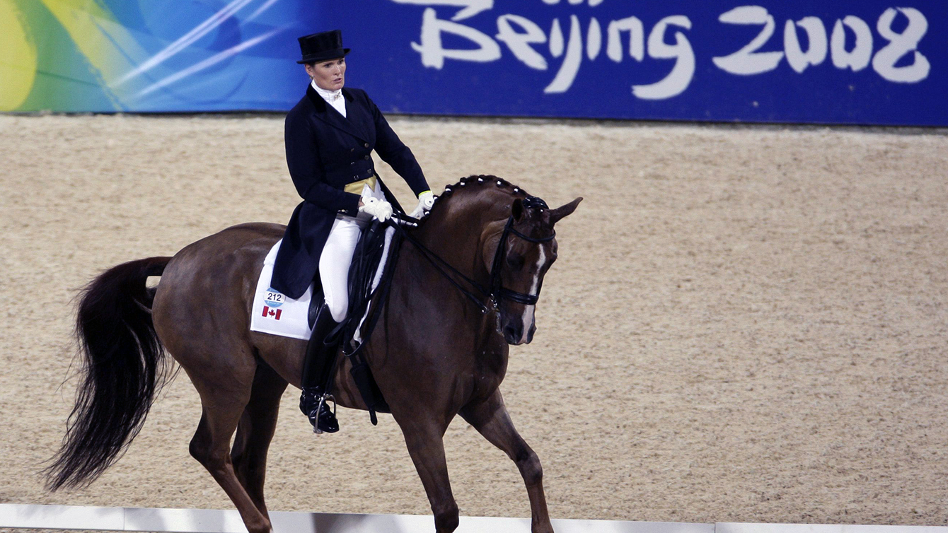 Canada's Ashley Holzer riding her horse Pop Art competes at the Equestrian Grand Prix Special Dressage Individual competition of the Beijing 2008 Olympics Equestrian in Hong Kong, Saturday, Aug. 16, 2008. (AP Photo/Kin Cheung)
