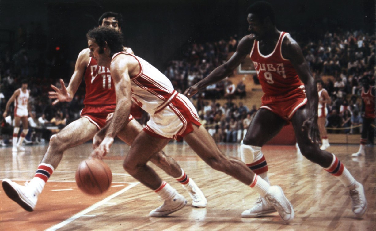 1976 photo of Canadian player dribbling towards the net in a basketball game