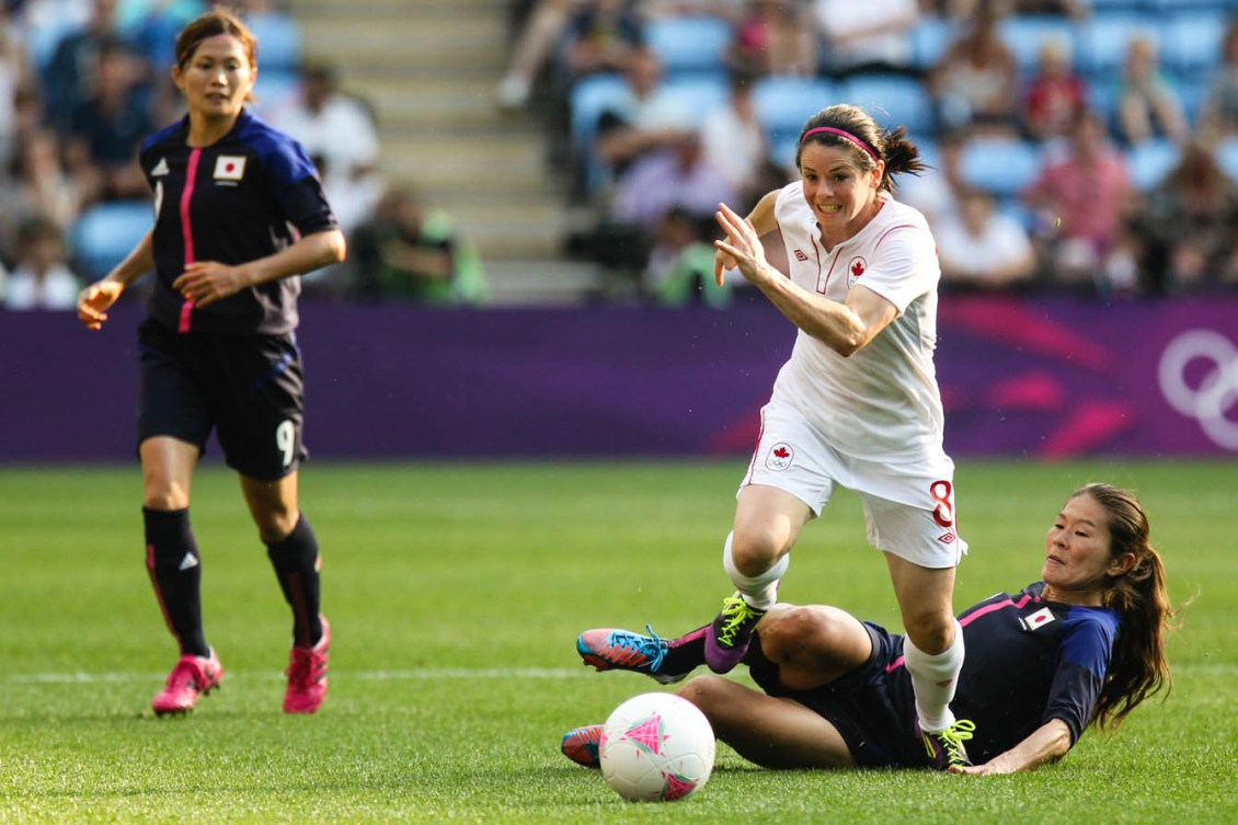 Diana Matheson dribbles the ball past an opponent.