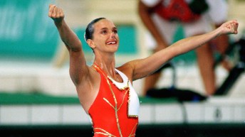 Sylvie Fréchette celebrates with her arms in the air