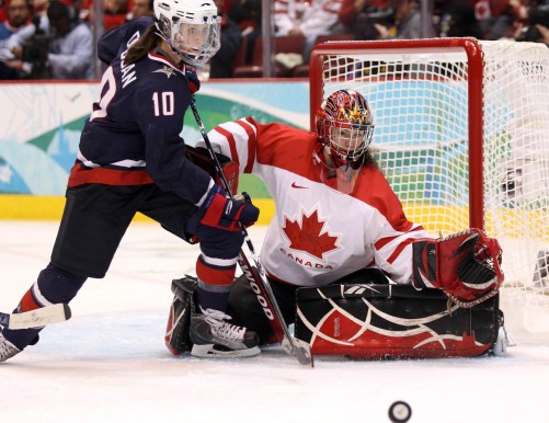USA's Meghan Duggan and Canada's goaltender Shannon Szabados keep their eyes on the puck during second period women's gold medal Olympic hockey action at the 2010 Winter Olympic Games in Vancouver, Thursday, Feb. 25, 2010. THE CANADIAN PRESS/Jonathan Hayward