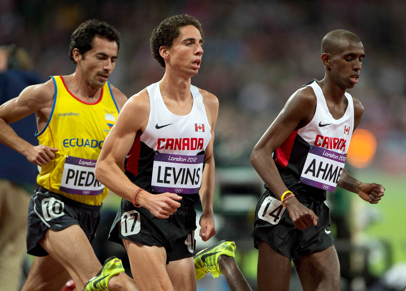 Canada's Cameron Levins, centre, and Ahmed Mohammed, right, pass Ecuador's Bayron Piedra, left, in the men's 10000-metre final at London 2012. (Photo: CP/Ryan Remiorz)