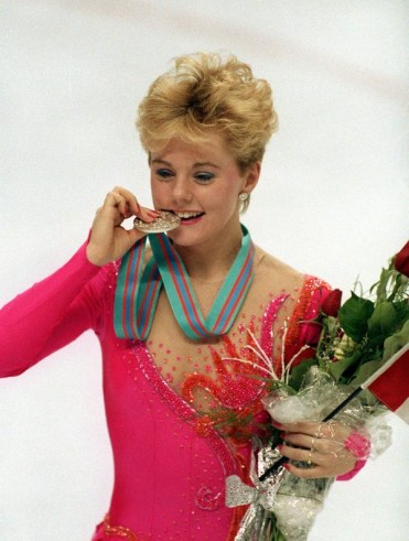 Elizabeth Manley bites the silver medal she won at Calgary 1988.