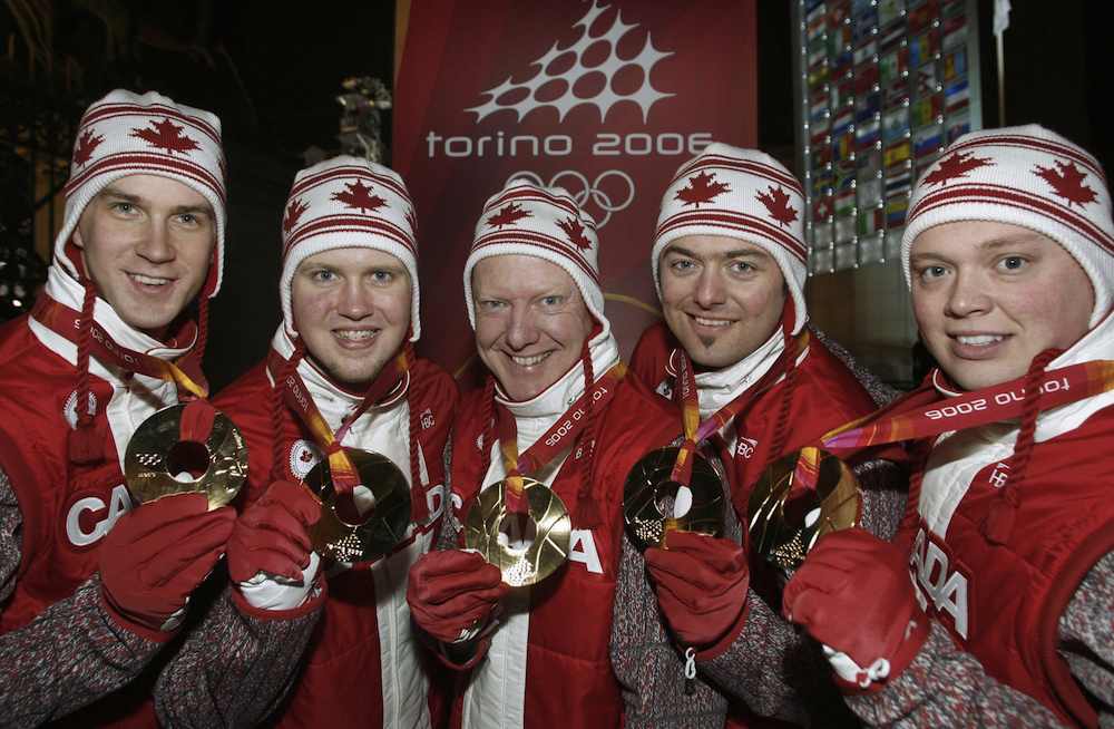 Canadian athletes posing with their medals