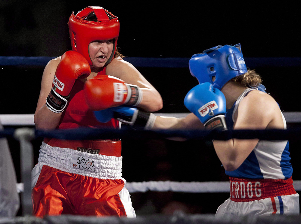 Boxer, Mary Spencer in the ring taking a punch