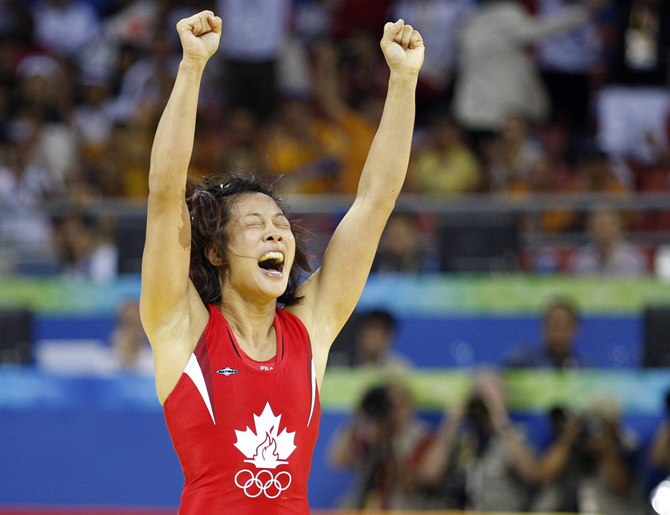 Carol Huynh celebrates winning wrestling gold at Beijing 2008. 