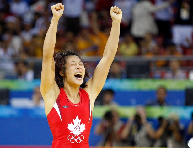 Canada's Carol Huynh from Hazelton, B.C. celebatres her gold medal victory over Chiharu Icho from Japan in the women's freestyle 48kg wrestling final at the Beijing 2008 Summer Olympics in Beijing, Saturday, August 16, 2008.
