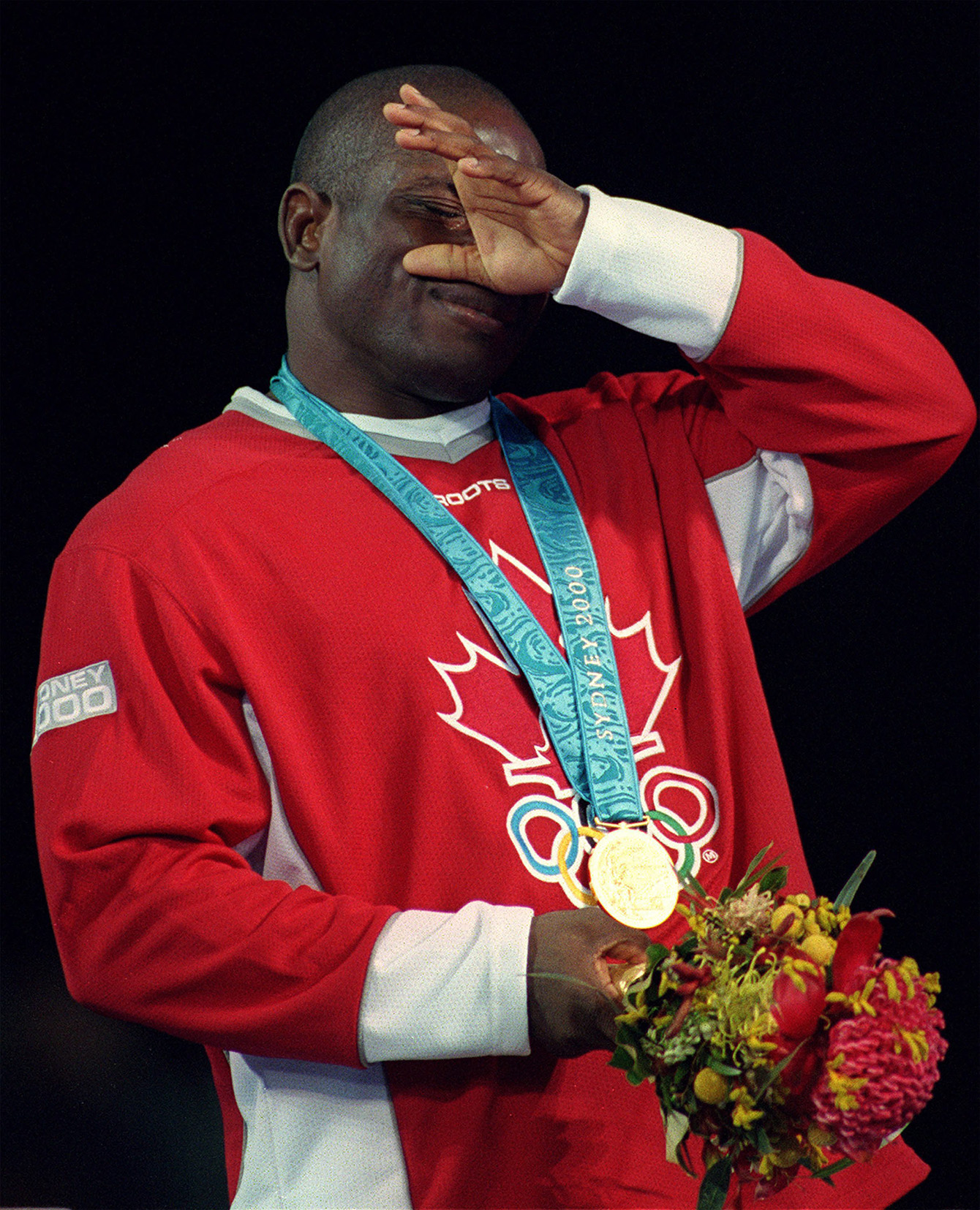 Igali wiping away tears on podium