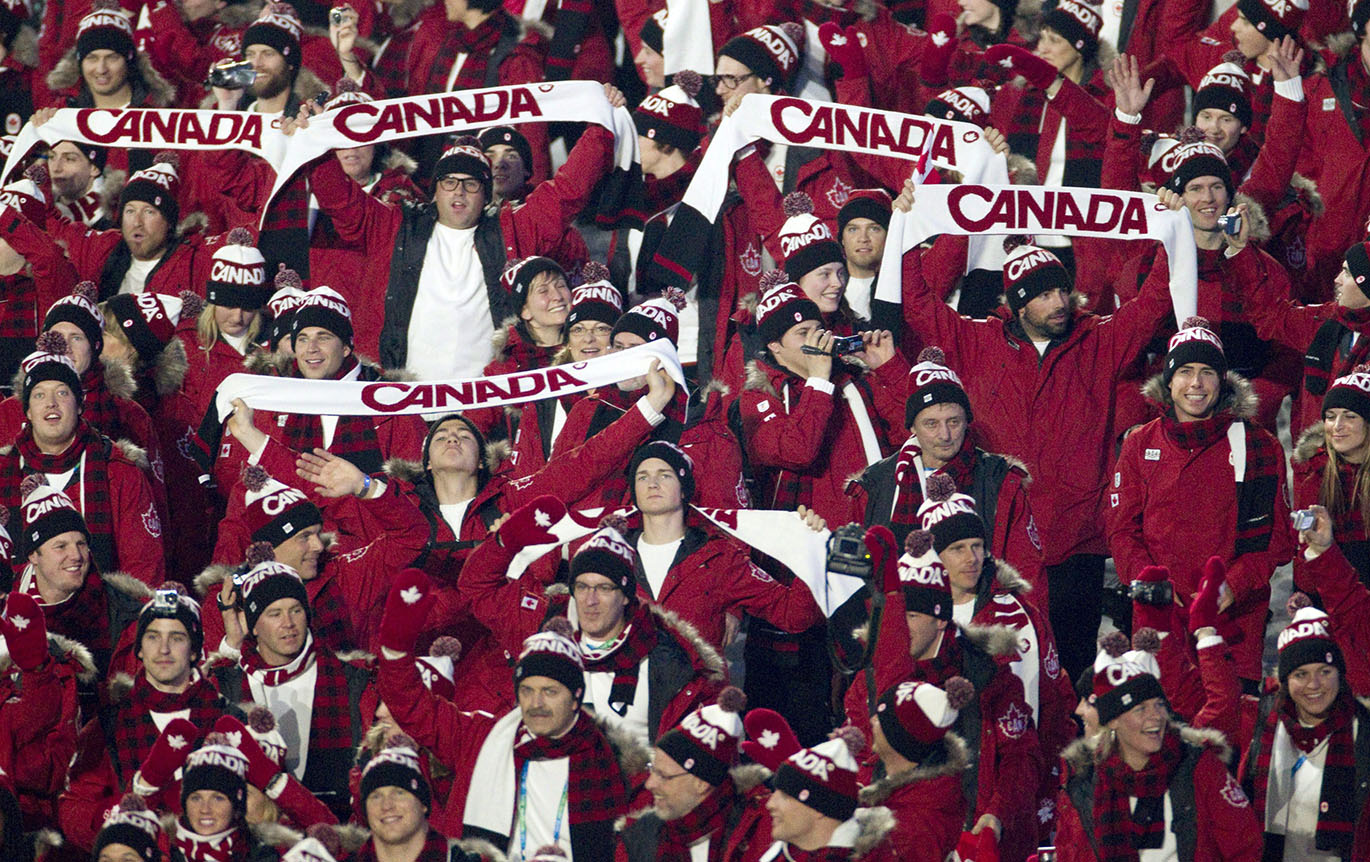 Canadian team members hold up Canada scarves during the athlete's parade at the opening ceremonies for the Vancouver 2010 Olympic Winter Games in Vancouver, Friday, Feb. 12, 2010. THE CANADIAN PRESS/Jonathan Hayward