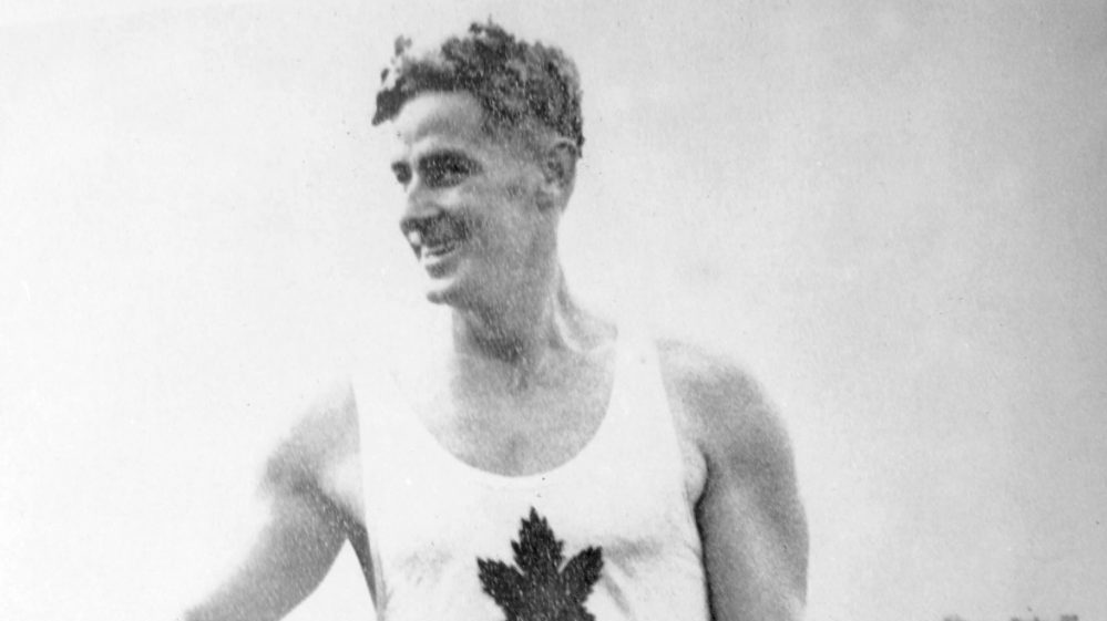 Canada's Frank Amyot celebrates a gold medal win in the 1,000m canoeing event at the Berlin 1936 Olympic Games (CP Photo/COC)
