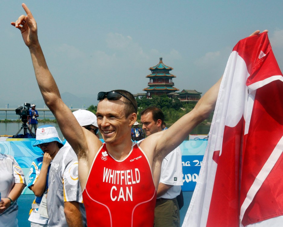 Simon Whitfield celebrates in Beijing, he was also Canada's opening ceremony flag bearer at London 2012.