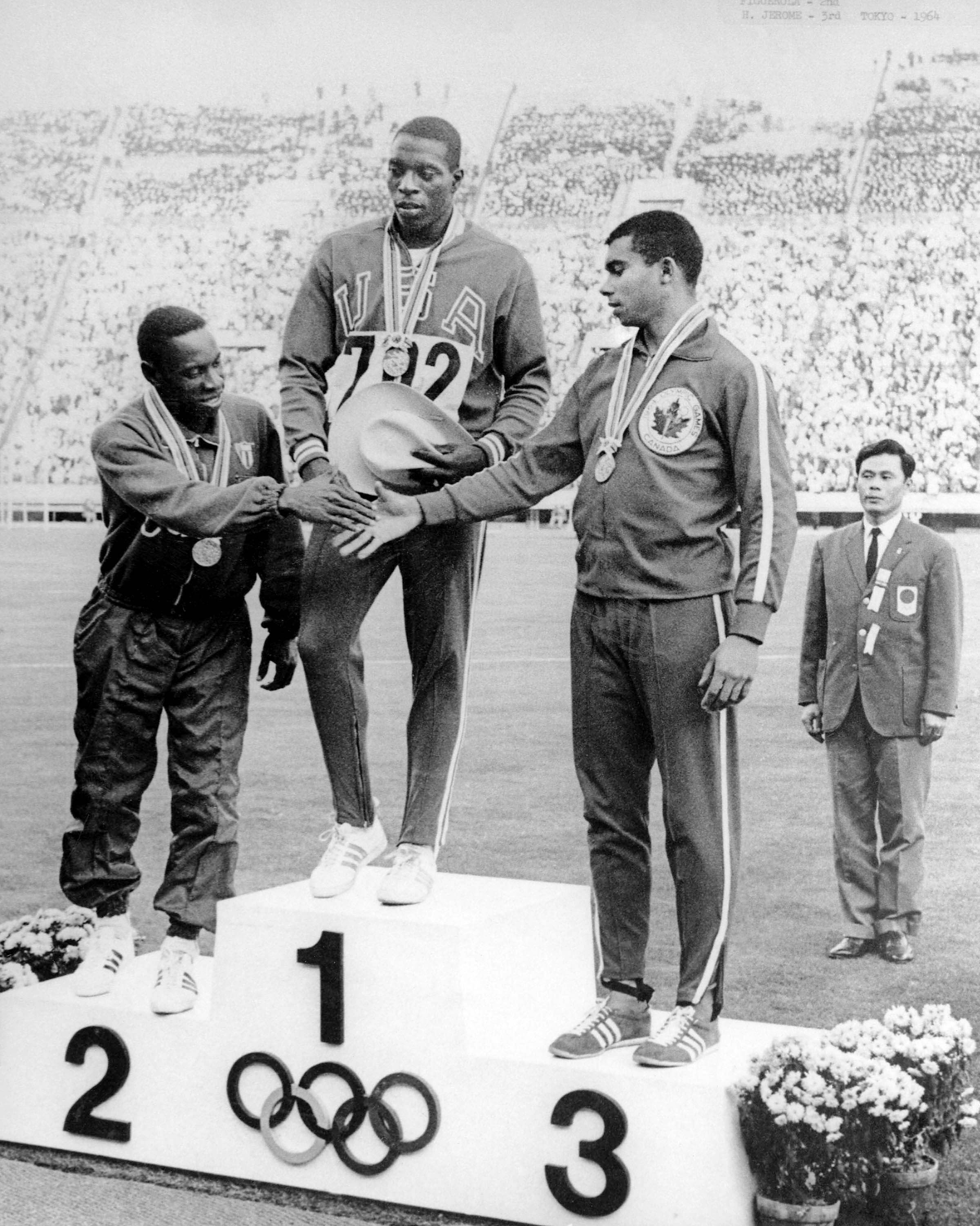 Harry Jerome (right) celebrates his bronze medal win in the 100m athletics event at the Tokyo 1964 Olympic Games. (CP Photo/COC)