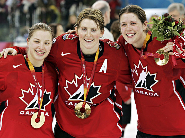 Colleen Sostorics, Hayley Wickenheiser and Gillian Apps wear Olympic gold medals on their jerseys 