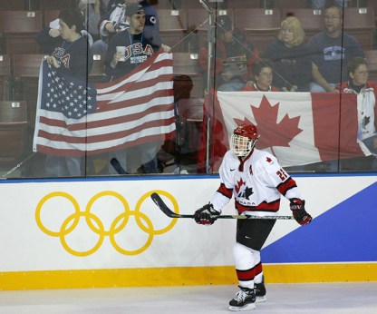 Canada's Hayley Wickenheiser, of Shaunavon, Sask., skates past US and Canadian fans during the warm-up prior to the gold medal ladies hockey game at the Olympic Winter Games in Salt Lake City, Utah, Thursday Feb. 21, 2002. (CP PHOTO/Paul Chiasson)