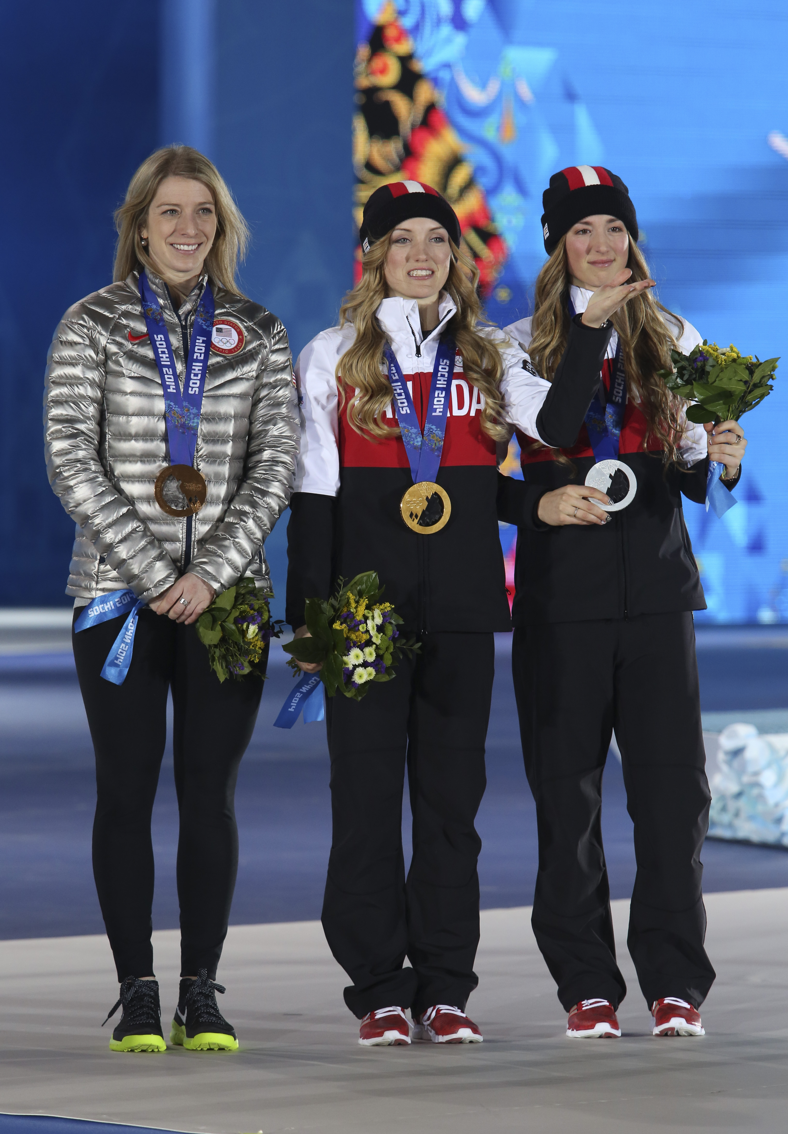Justine Dufour-Lapointe receives her gold medal and her sister Chloe a silver