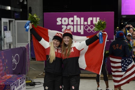 Kaillie Humphries and Heather Moyse celebrating with the Canadian flag