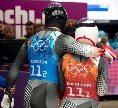 Canada's Samuel Edney (left) places his arm around teammate Alex Gough following their teams fourth place finish in the Luge Team Relay at the Sochi Winter Olympics in Krasnaya Polyana, Russia, Thursday, Feb. 13, 2014. THE CANADIAN PRESS/Jonathan Hayward