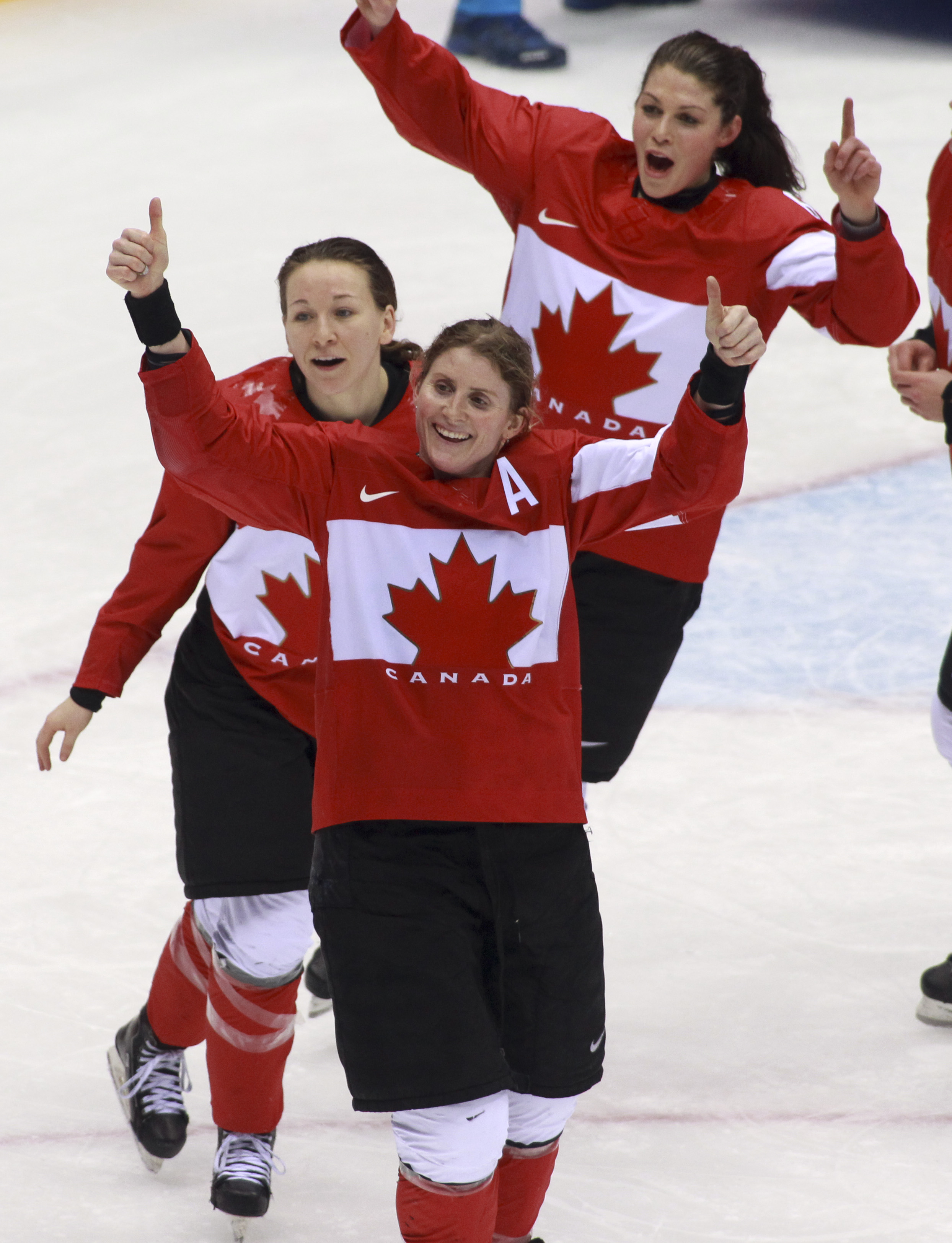 Team Canada celebrates beating Team USA in the gold medal women's hockey match