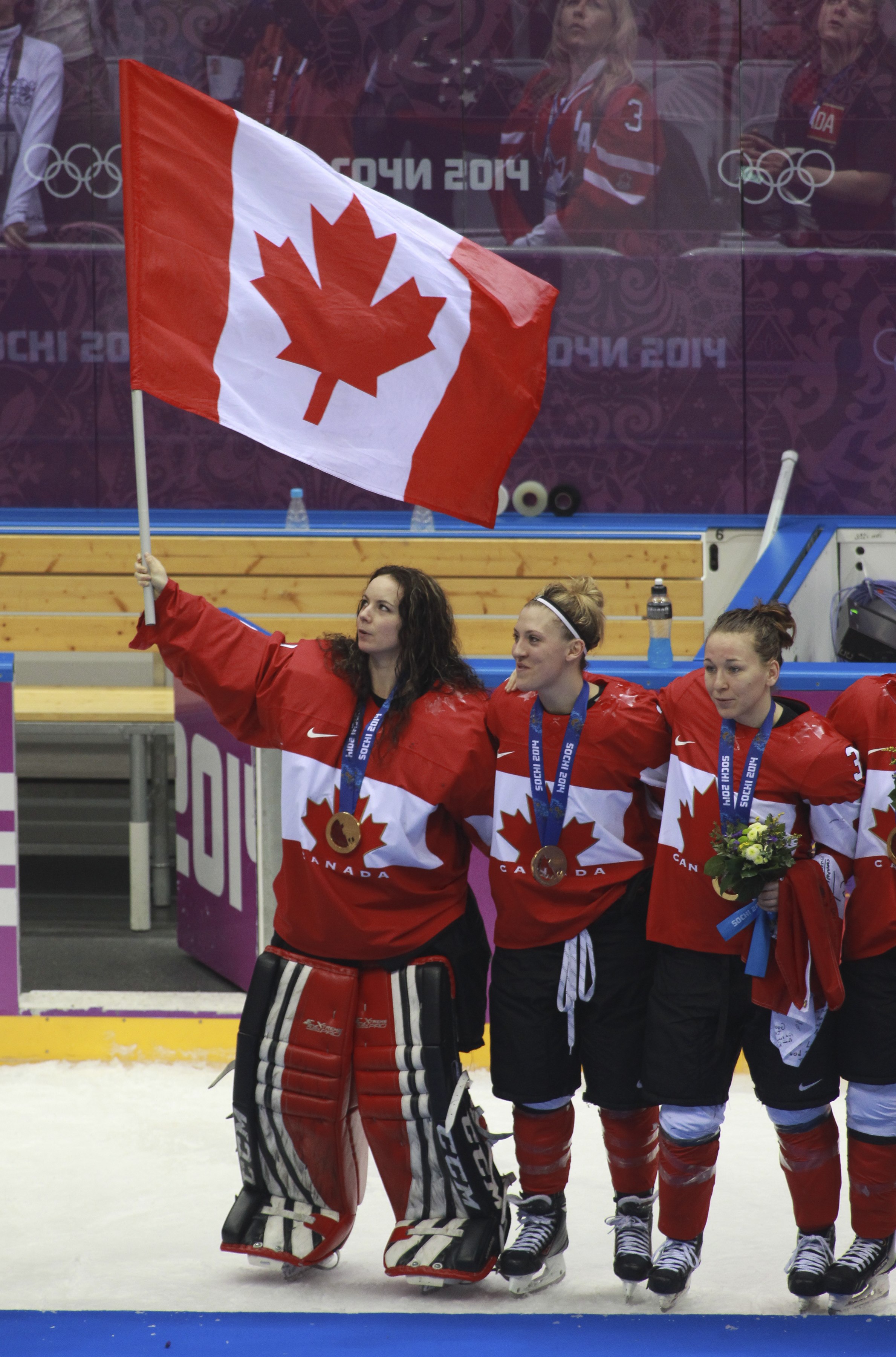 Team Canada celebrates beating Team USA in the gold medal women's hockey match