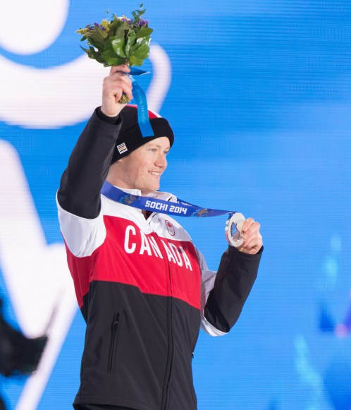 Mike Riddle receives the silver medal in men's ski halfpipe at the 2014 Sochi Winter Olympics