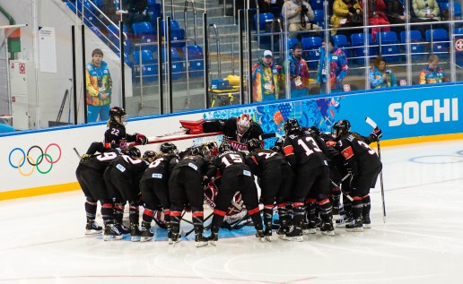 Canada's women's hockey team form a team huddle