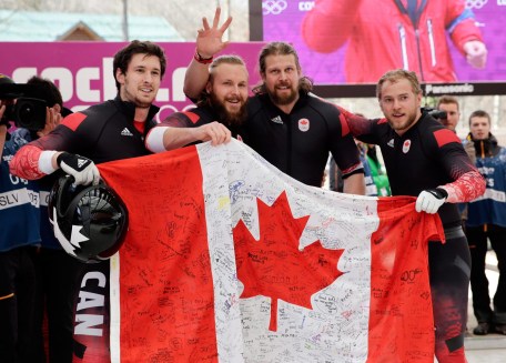 Team Canada members with a Canadian flag