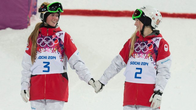 Canada's Justine Dufour-Lapointe and Chloe Dufour-Lapointe holds hands before climbing