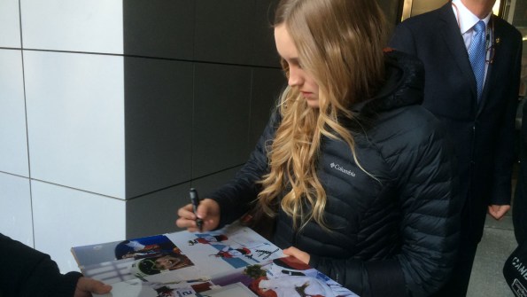 Justine autographs one of the famous podium photos from Sochi 2014.