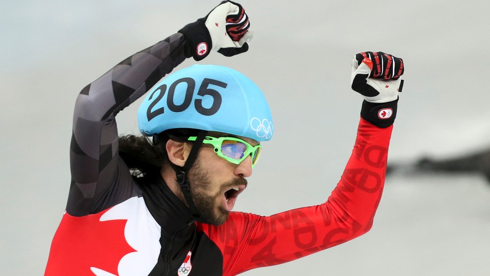 Charles Hamelin celebrates winning his third career Olympic gold medal after finishing first in the 1500m at Sochi 2014.