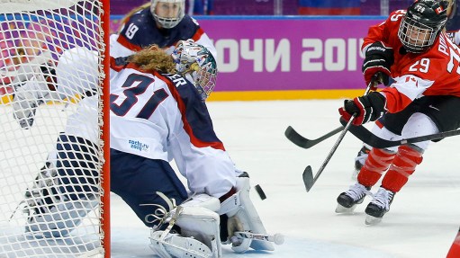 Marie-Philip Poulin of Canada (29) shoots to score the tying goal against USA goalkeeper Jessie Vetter (31) during the third period of the women's gold medal ice hockey game at the 2014 Winter Olympics, Thursday, Feb. 20, 2014, in Sochi, Russia. (AP Photo/Matt Slocum)