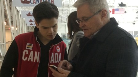 Hockey commentator Bob McKenzie exchanges contact info with Mikaël. They're BFFs now.