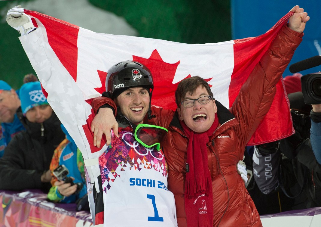 brothers embracing holding Canadian flag