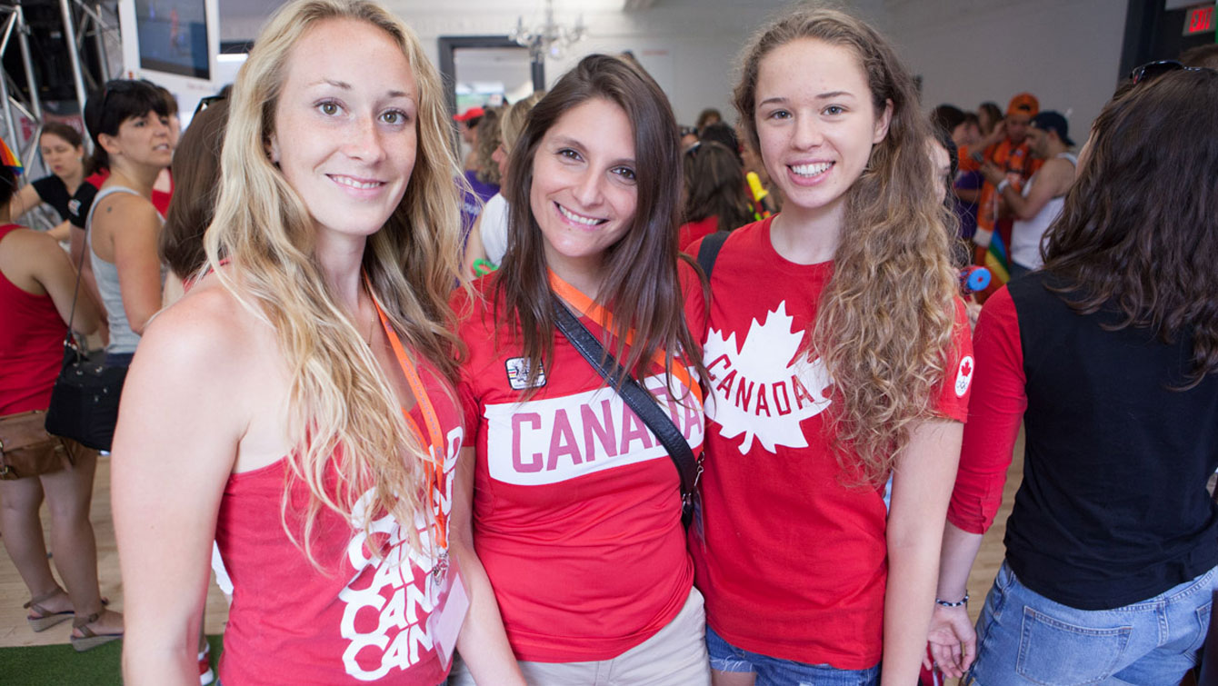 London 2012 gymnasts Rosie Cossar (left) and Anastasiya Muntyanu (right) join fencer Sandra Sassine (Beijing 2008, London 2012) at PrideHouseTO prior to the march.