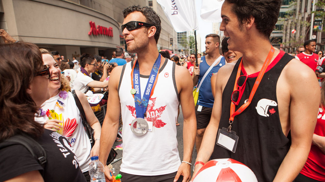 Sochi silver medallist (team figure skating) Eric Radford (left) and fellow 2014 Olympian John Fennel (luge) enjoying the march at Pride.