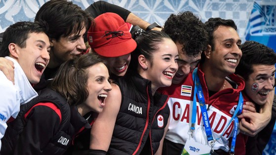 Canada's figure skating team congratulates Kaetlyn Osmond after a performance in the team event at Sochi 2014.