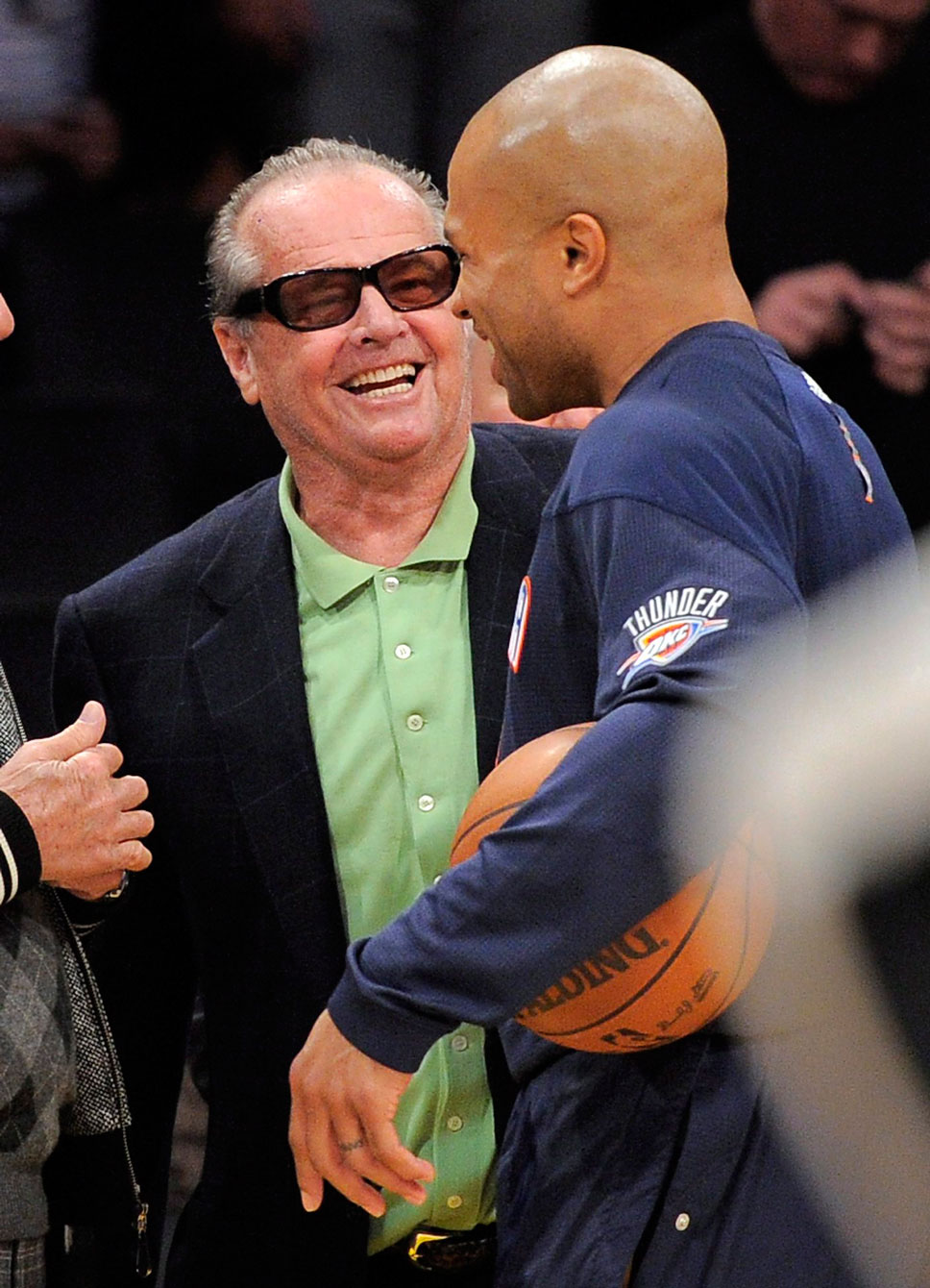 Nicholson jokes around with former Laker Derek Fisher. Photo: CP