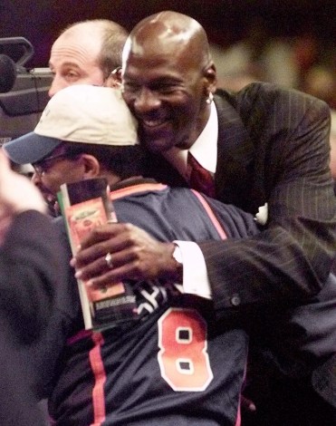 Spike Lee gets a hug from Michael Jordan. Photo: CP
