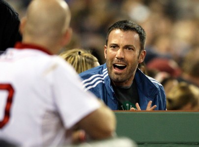 Ben Affleck talking with players in the dugout during a Red Sox game. Photo: CP